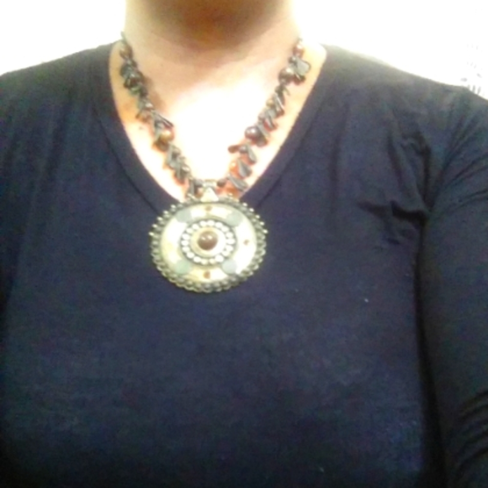 Woman beaded necklace with medallion.